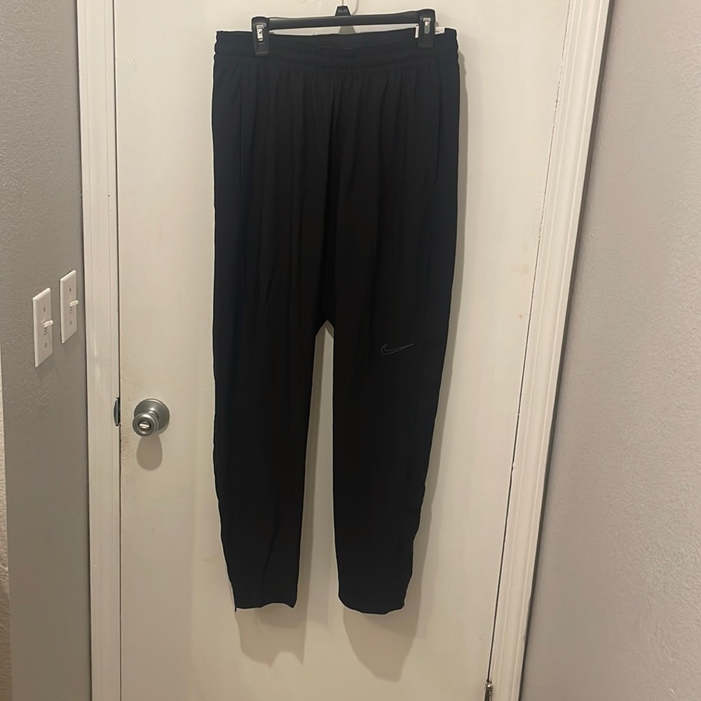 Nike athletic pants. Brand new! Tapered at bottom with zippers